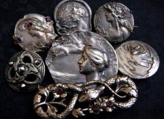 Art Nouveau by Moonlight Serpents and Sorceresses—a decadent assortment of antique Art Nouveau brooches and buttons, including interlaced serpents accented with shimmering garnets and marcasite, a fluttering of bats, plus the witchy women who are perfectly content to share their time with either (and perhaps be convinced to tell your fortune while doing so).