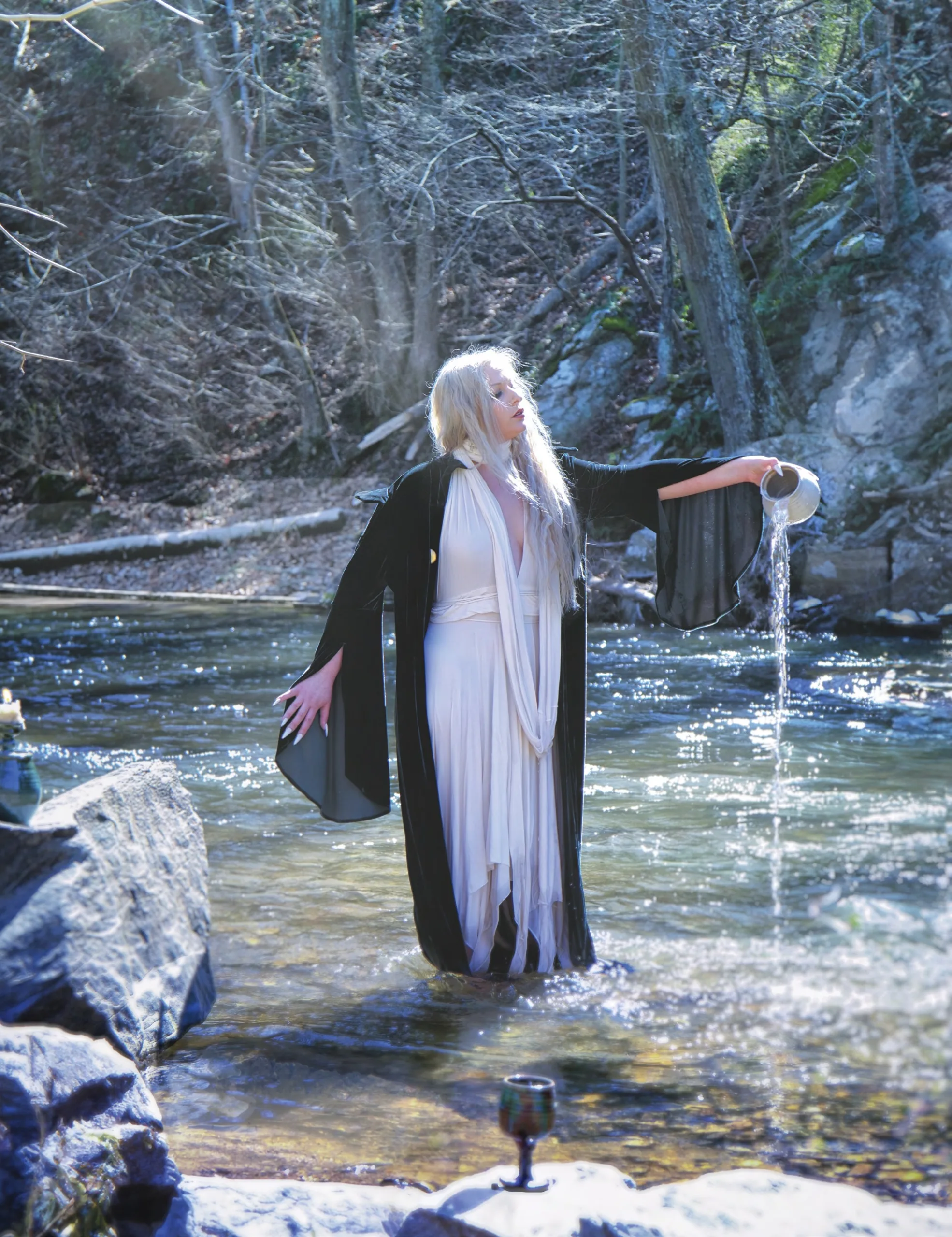 Rachael Platt_By_steve_parke_02 Winter Enchantment: Ceramicist Rachael Platt holding a lit manifesting jar under the full moon, surrounded by illuminated jars in a forest setting. Photography by steve parke