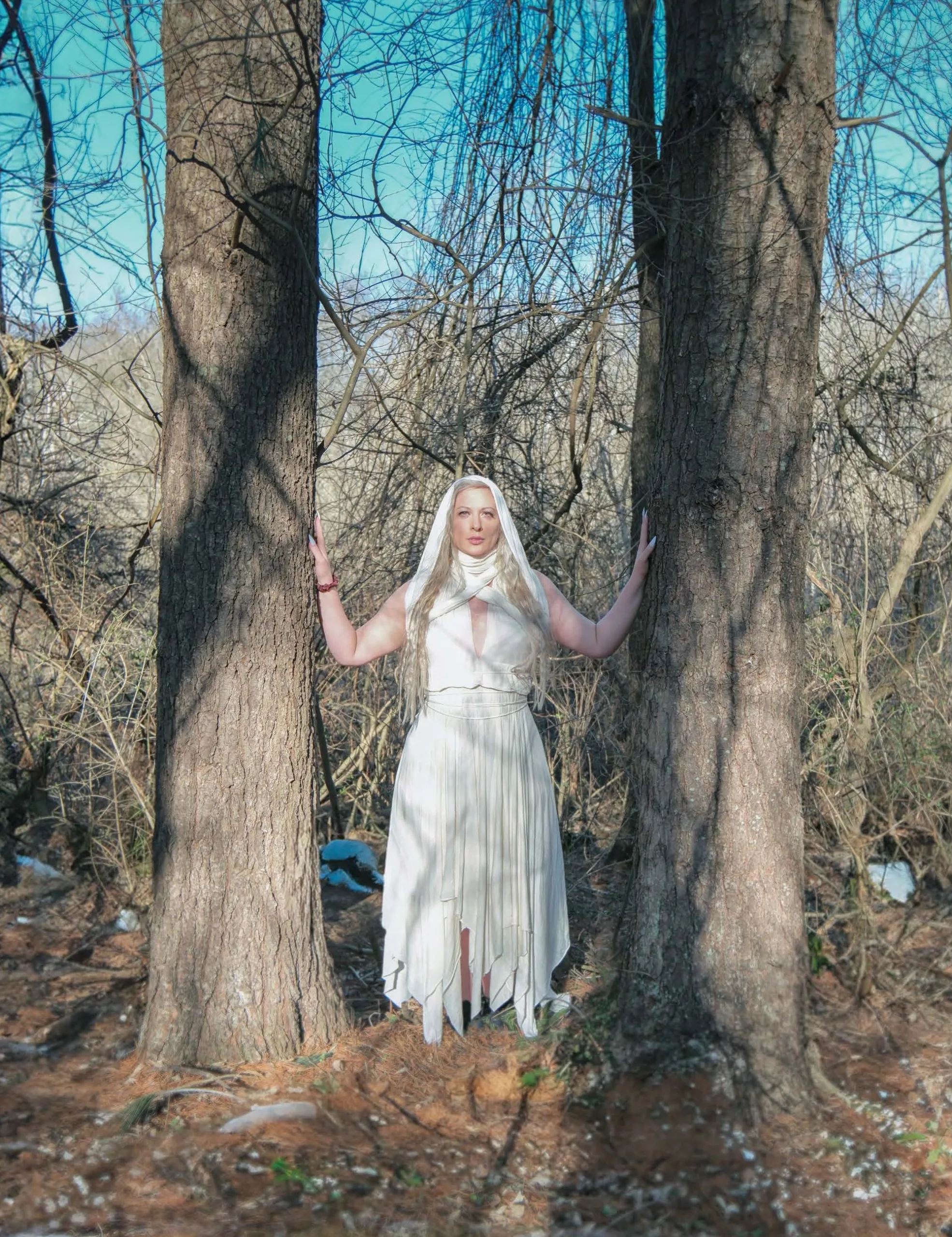 Rachael Platt_By_steve_parke_08 Winter Enchantment: Ceramicist Rachael Platt holding a lit manifesting jar under the full moon, surrounded by illuminated jars in a forest setting. Photography by steve parke
